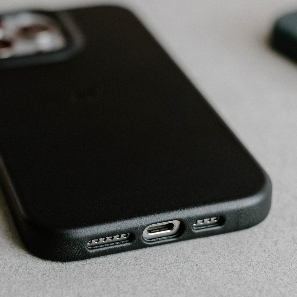 Close-up of a black phone case with a USB-C port and speaker holes.