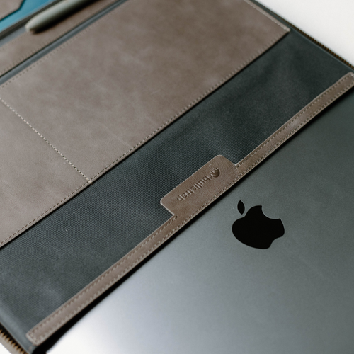 Interior view of Leather MacBook Sleeve showing compartments and Apple logo