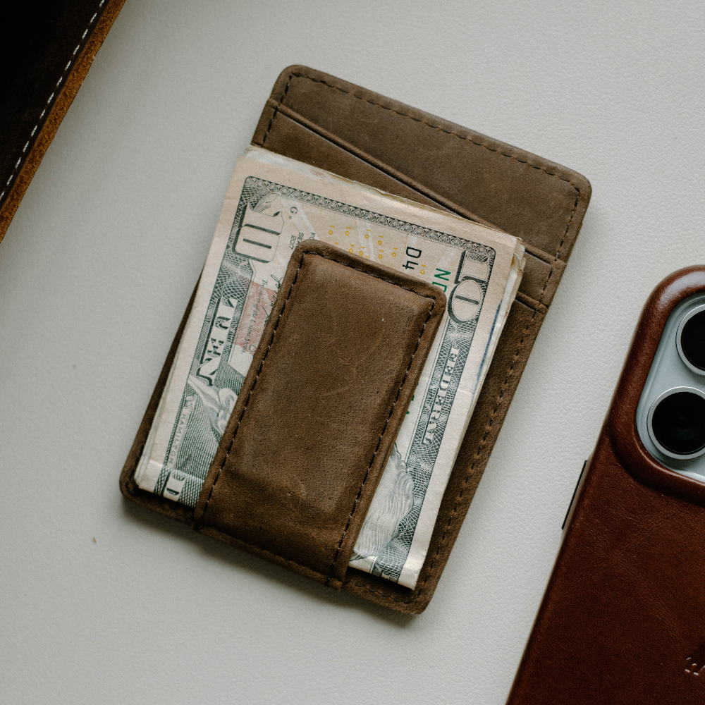 Brown leather money clip wallet with cash inserted