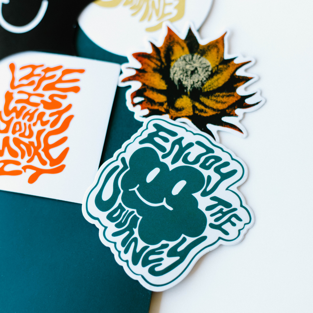 A collection of stickers including 'Enjoy the Journey' and floral designs.