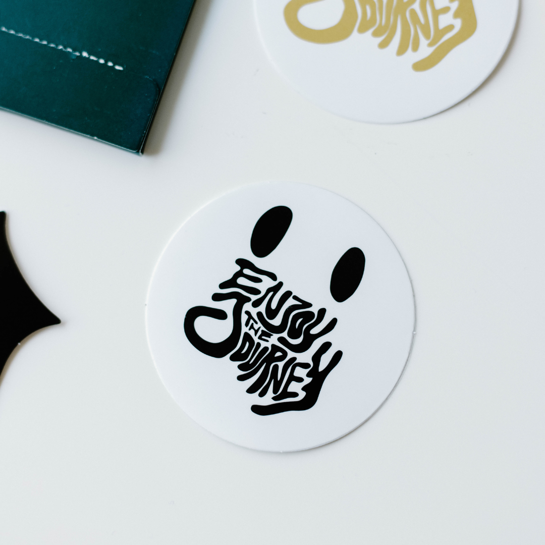 Sticker with the text 'Enjoy the Journey' in black and white