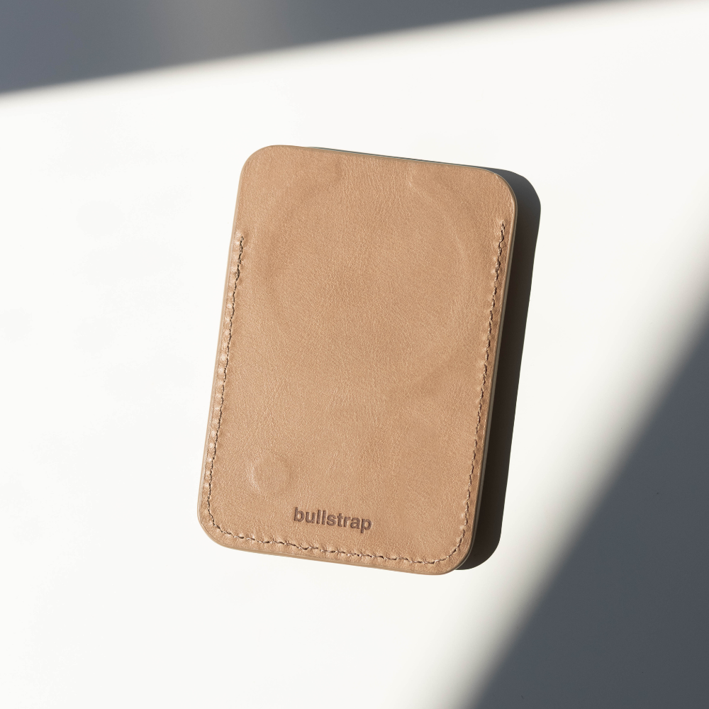 Tan Dune leather card wallet with stitched edges and embossed 'bullstrap' logo centered at the bottom.