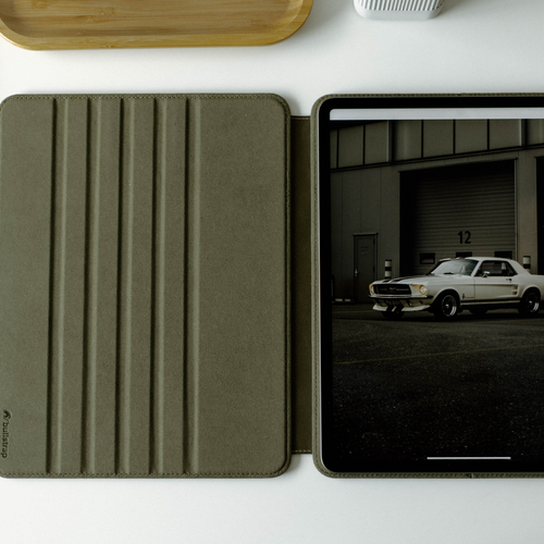 Leather iPad Case - MAVERICK with a green exterior and an iPad displayed inside.
