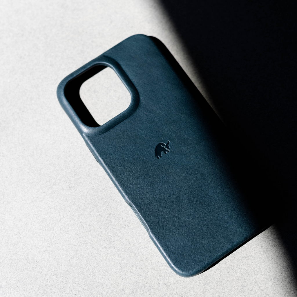 The Minimalist Case in Ocean color, showcasing its sleek design and embossed logo.