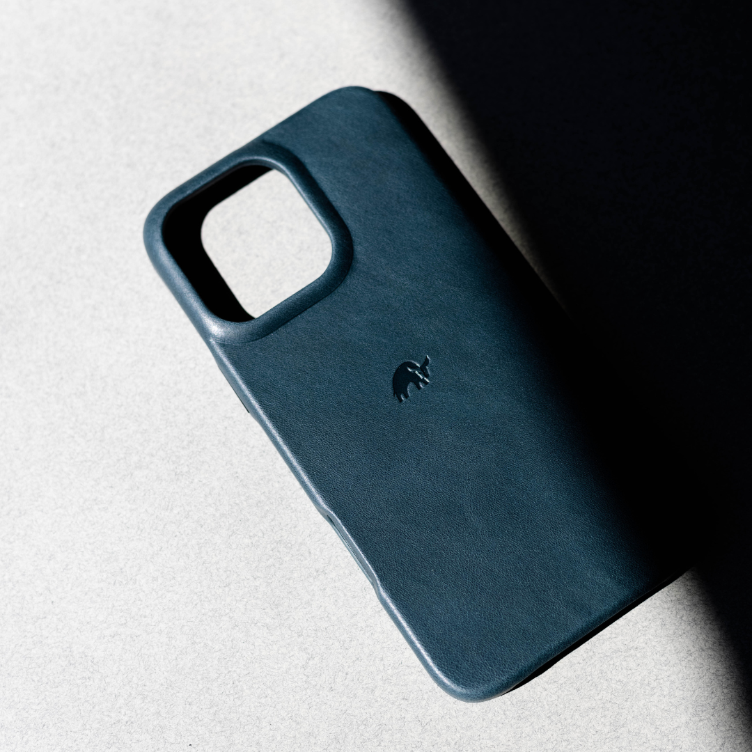 The Minimalist Case in Ocean color, showcasing its sleek design and embossed logo.