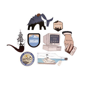 A collection of stickers featuring mountains, trees, and text including 'Enjoy Your Journey' and 'Made to Last'.