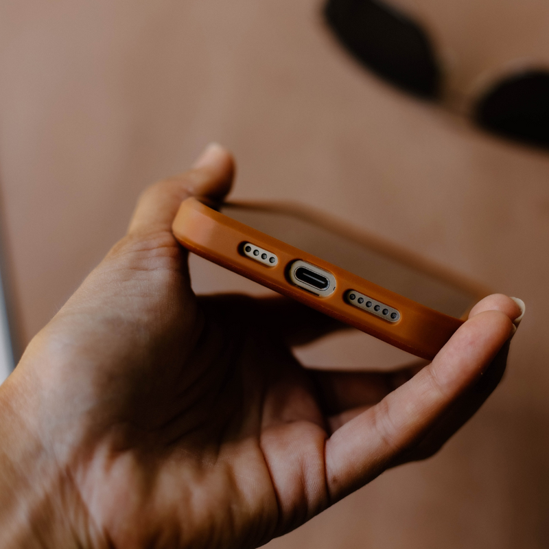 Close-up of the bottom of the Bullstrap Flex Case showing the charging port and speaker holes.