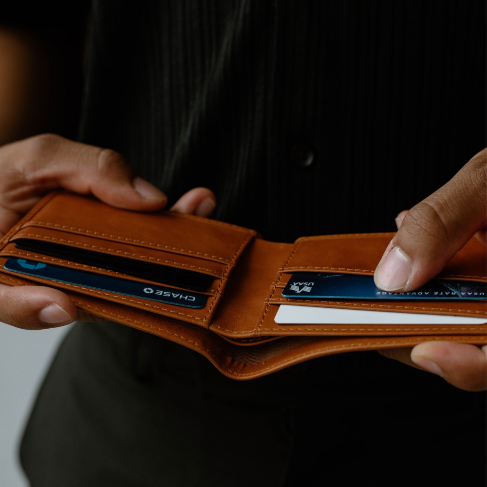 Sienna leather bifold wallet open showing card slots and credit cards labeled CHASE and USAA