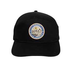 Black cap featuring a badge with 'ENJOY YOUR JOURNEY' and a mountain scene