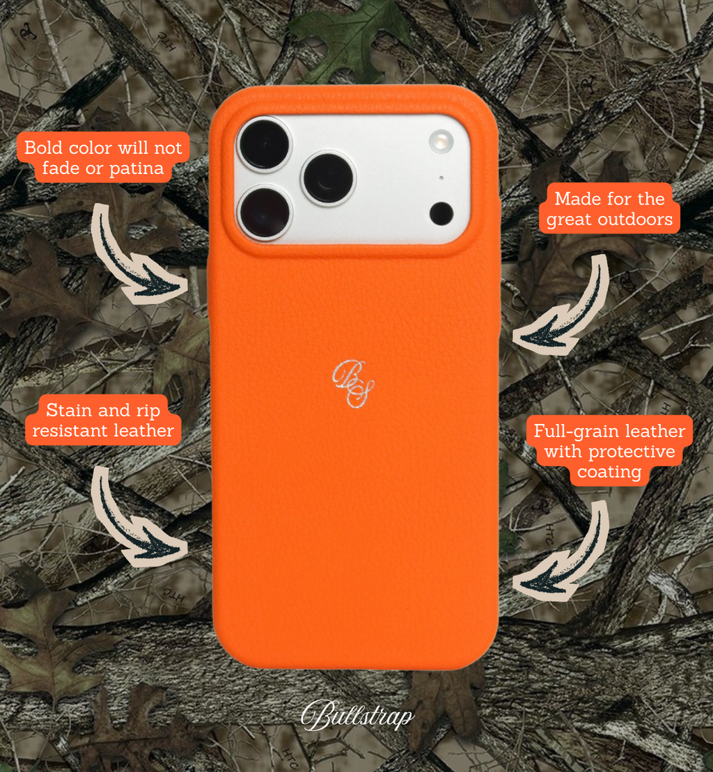 Front view of Performance Case in Blaze showcasing stain- and rip-resistant leather and bold color on camo background