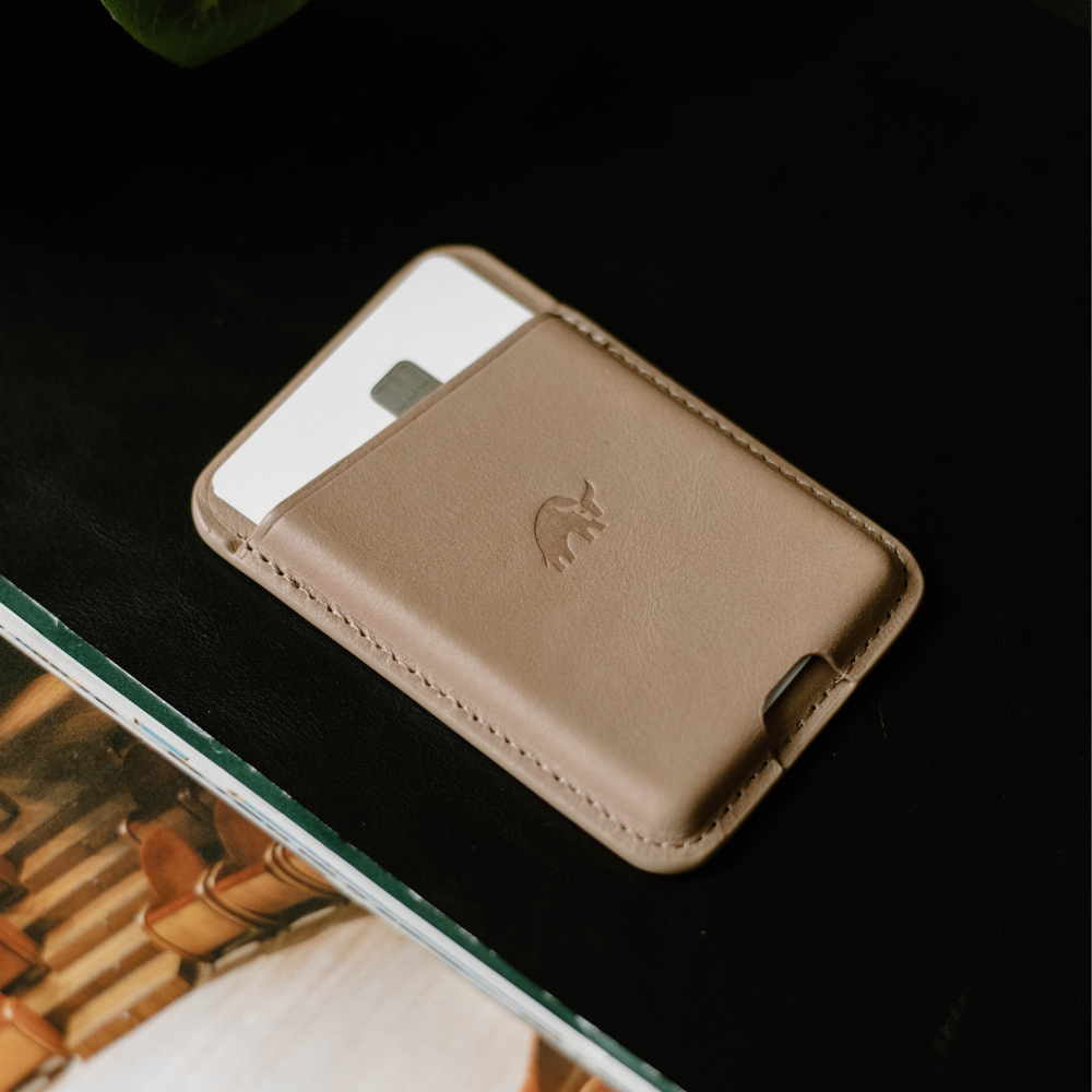 Dune leather magnetic wallet on a dark surface with a card visible