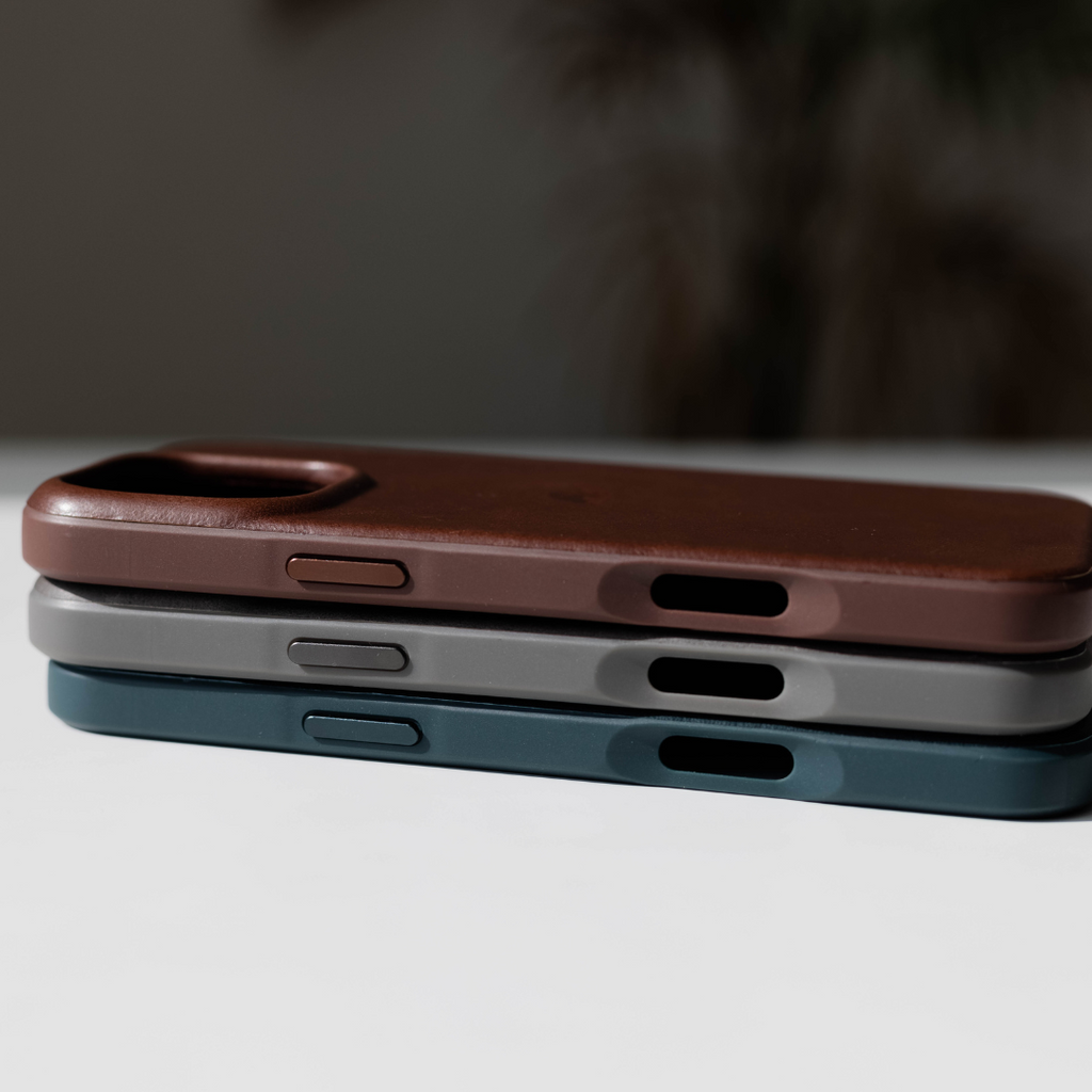 Three Flex Cases in Slate, Brown, and Gray stacked on a table