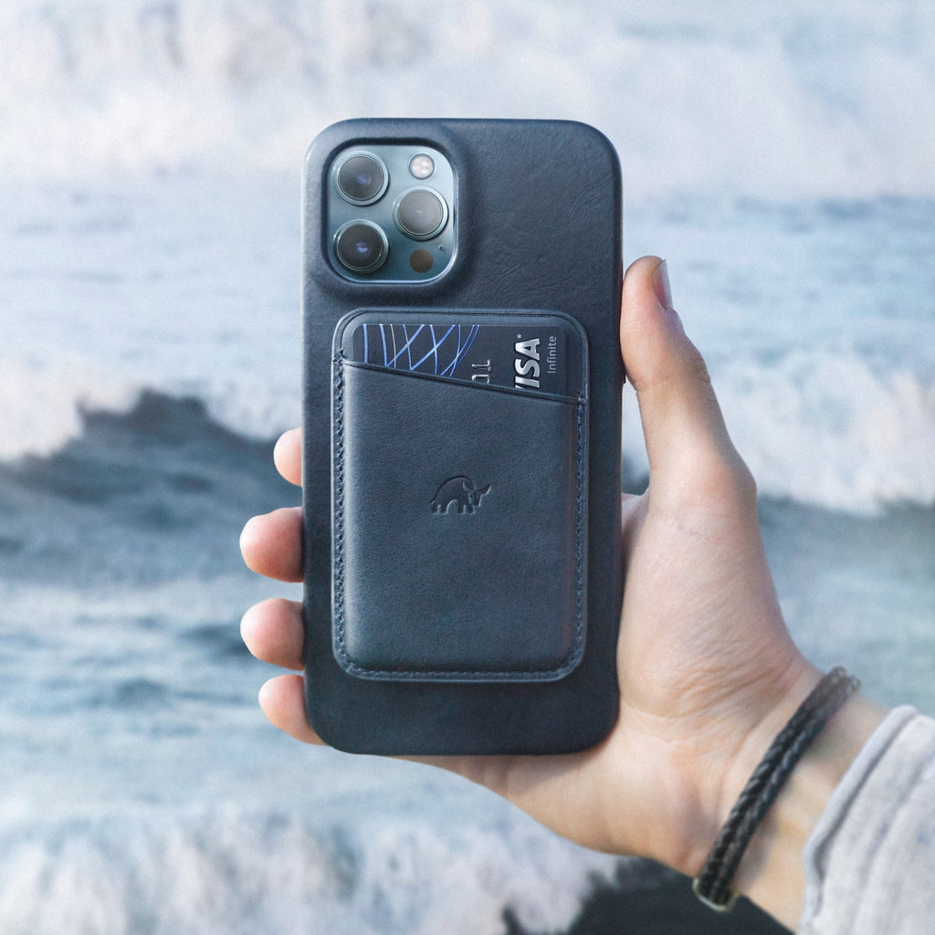 Leather magnetic card wallet attached to a phone case holding a card showing VISA Infinite