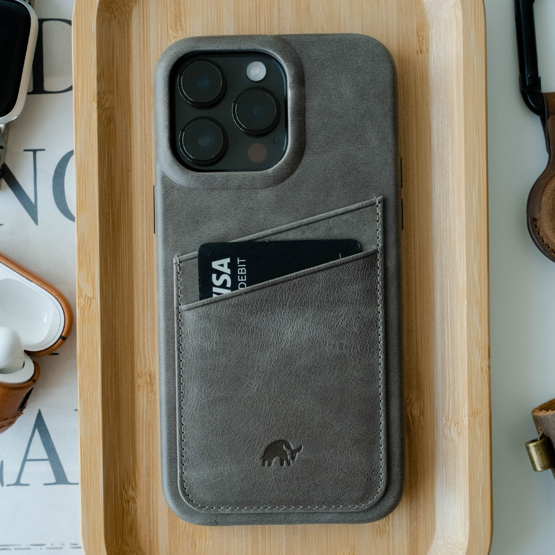 A gray phone case with a card slot, featuring a bull logo