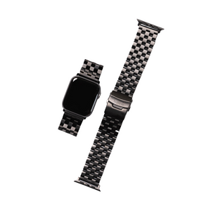 Matte black Apple Watch with a metal strap and a separate strap piece.