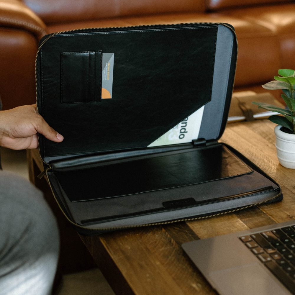 Open leather MacBook sleeve showing interior compartments and card holder
