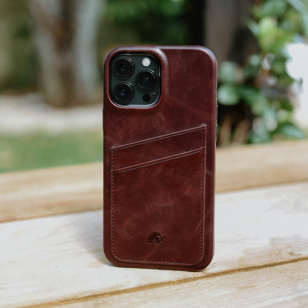 Brown leather iPhone case with card slot, featuring Bullstrap logo