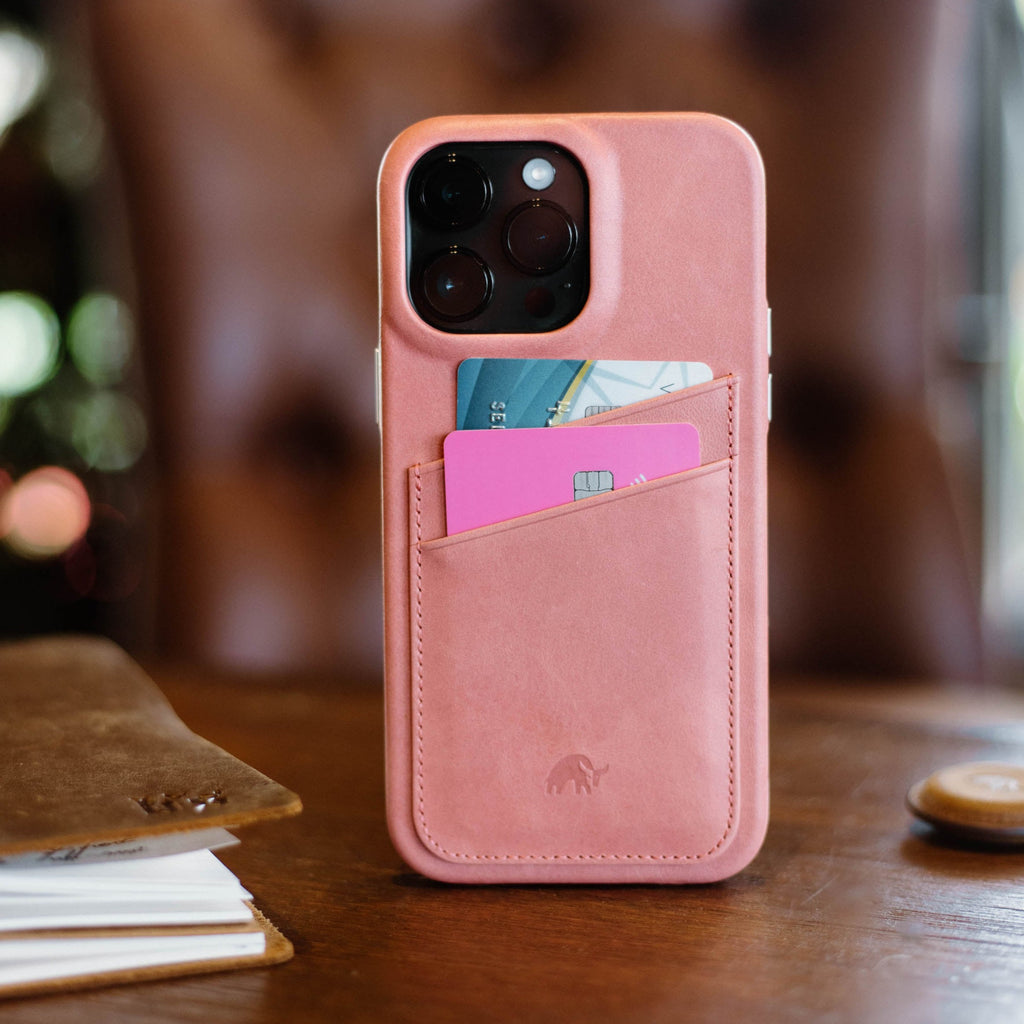 The Minimalist Portfolio Case in pink color, featuring card slots and a sleek design.