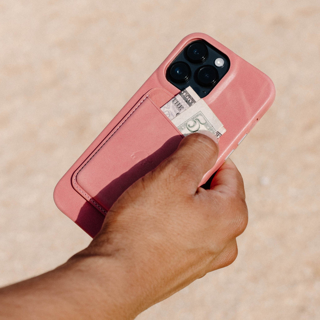 Pink South Beach minimalist smartphone case with rear card pocket holding a folded bill showing THE and 5