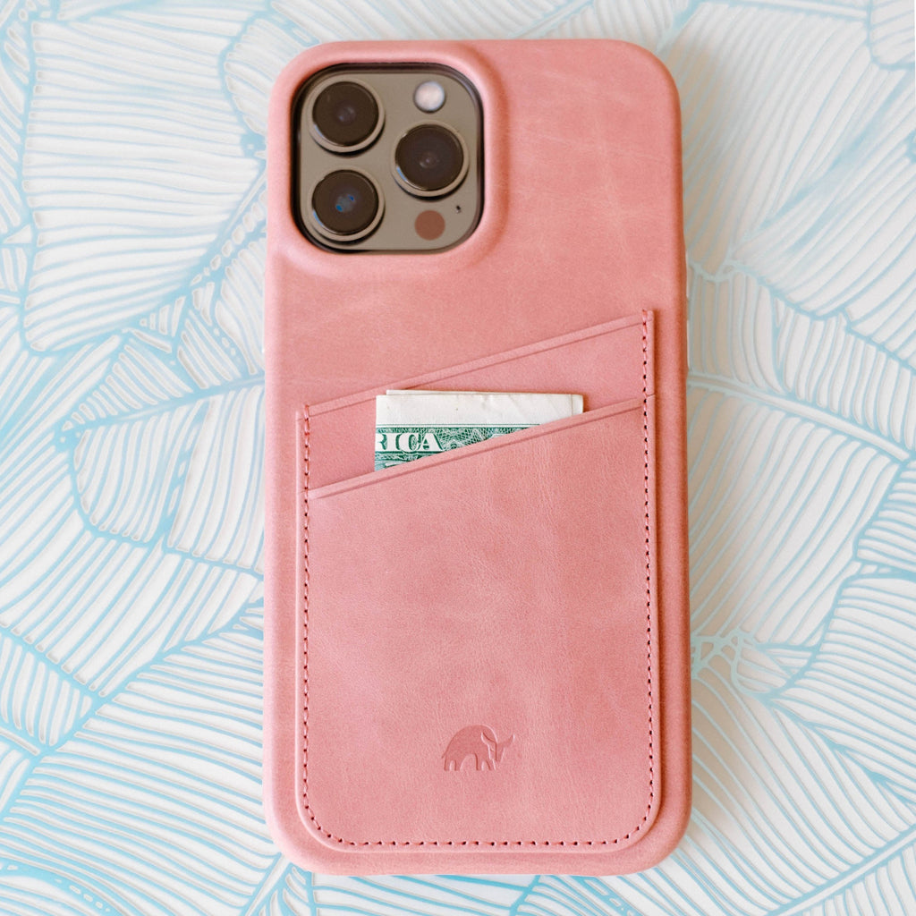 Pink leather iPhone case with card slot and a dollar bill peeking out