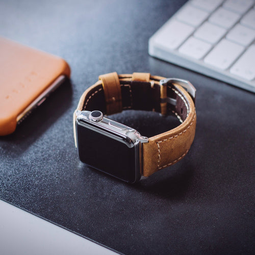Leather strap for Apple Watch on a desk with keyboard