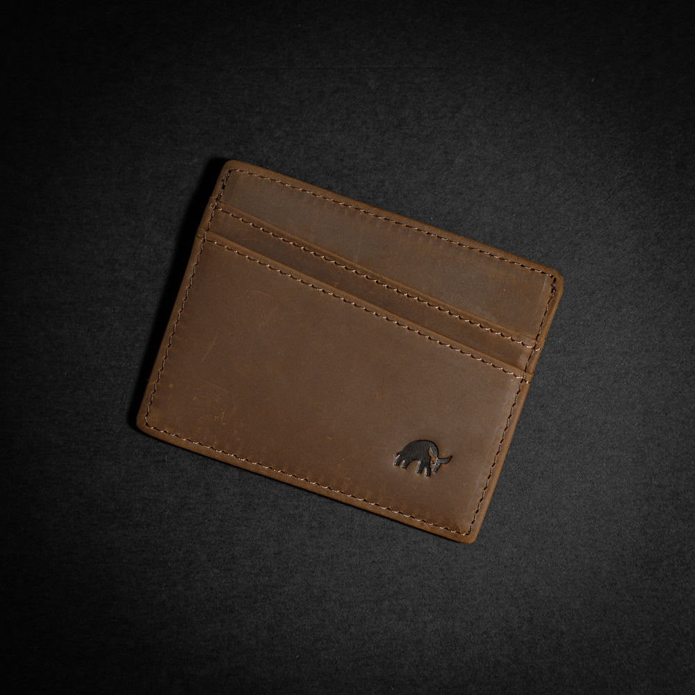 Brown leather card holder with embossed logo and multiple card slots