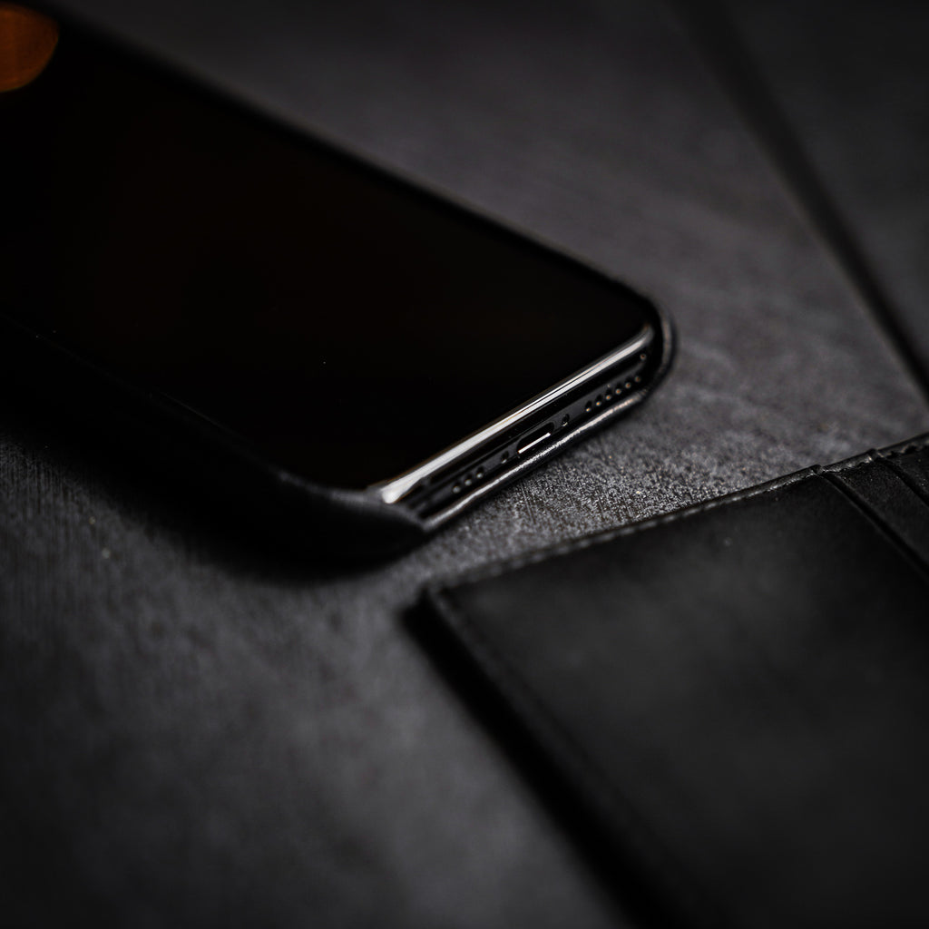 Close-up of the Minimalist Portfolio Case - BLACK EDITION with a phone showing its cut-out features