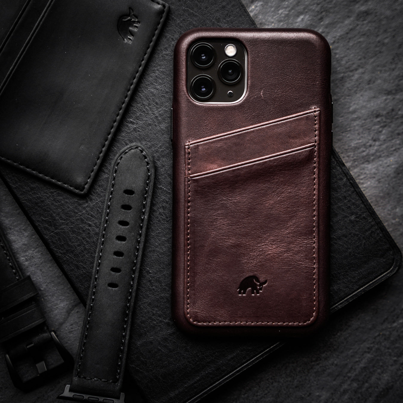 The Minimalist Portfolio Case in Bourbon color, featuring a card slot and embossed logo.
