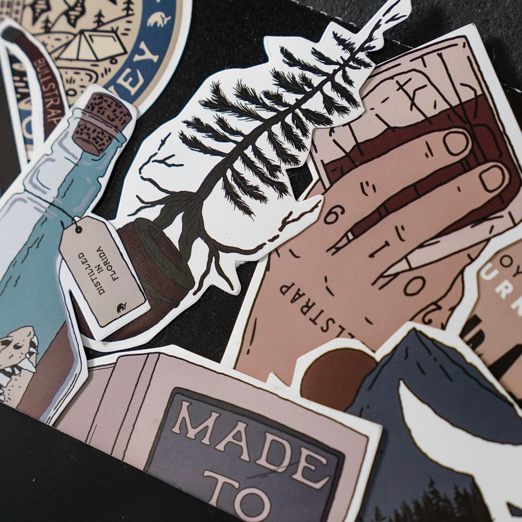 Assorted illustrated stickers: a hand holding a fern, a bottle tag reading 'DISTILLED IN FLORIDA', and a sticker reading 'MADE TO'.