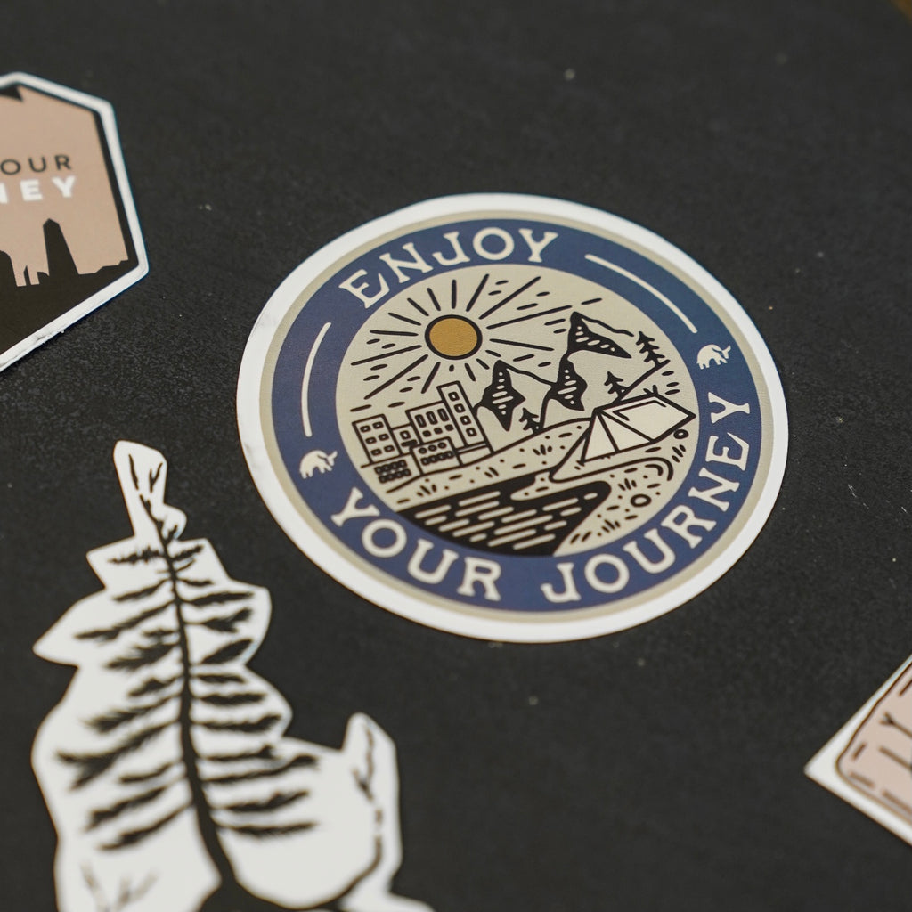 Sticker featuring a landscape with the text 'ENJOY YOUR JOURNEY'