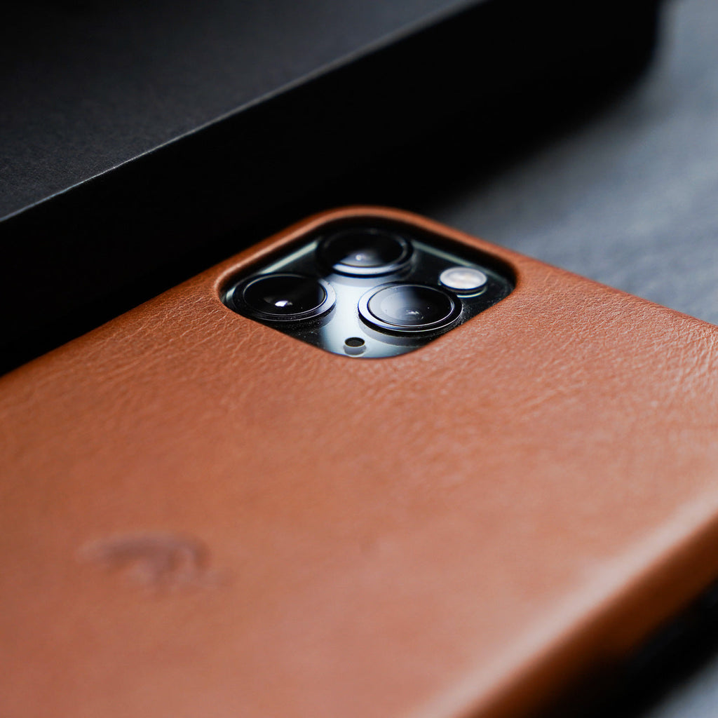 Close-up of a leather iPhone case showing camera cutout and texture
