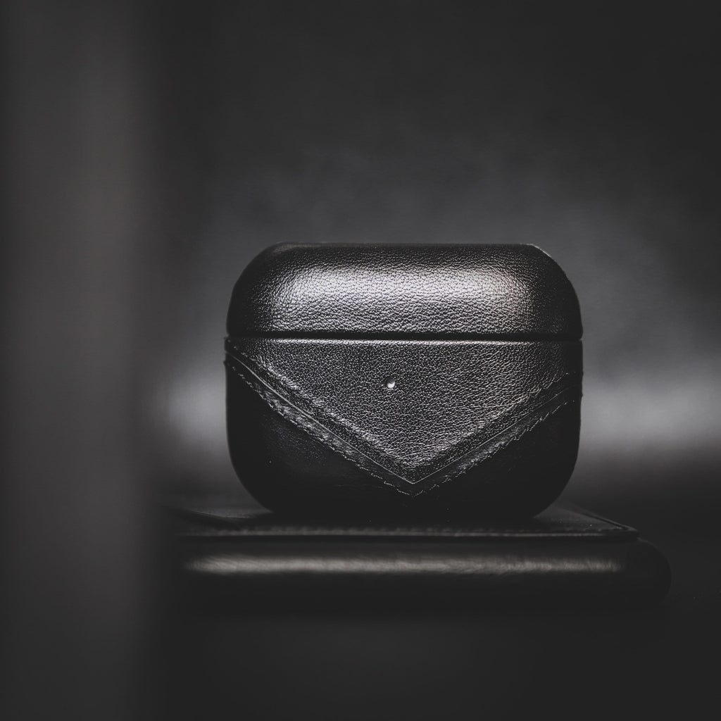Black leather AirPods case with a minimal design