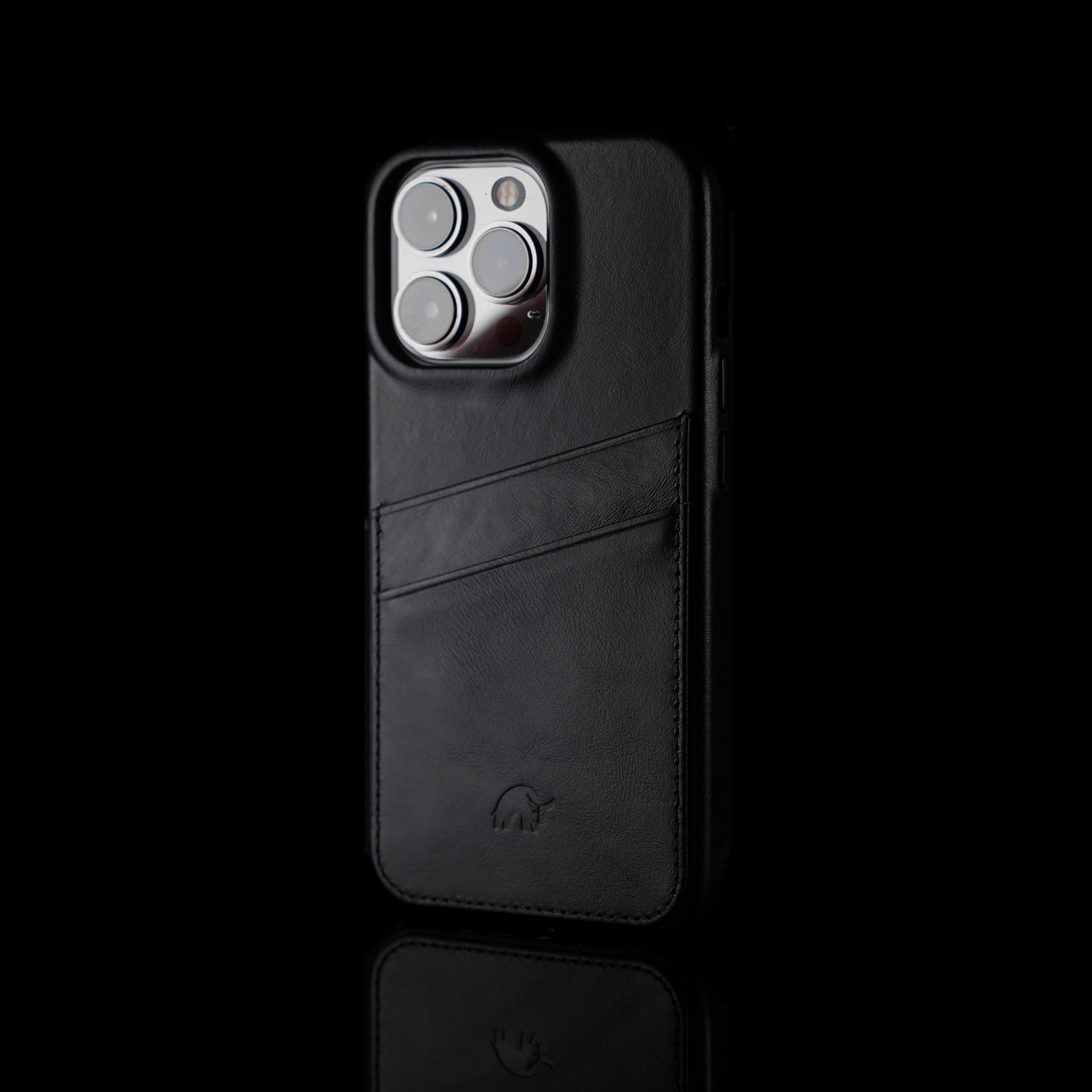 Black leather iPhone case with card slot, featuring a minimalist design