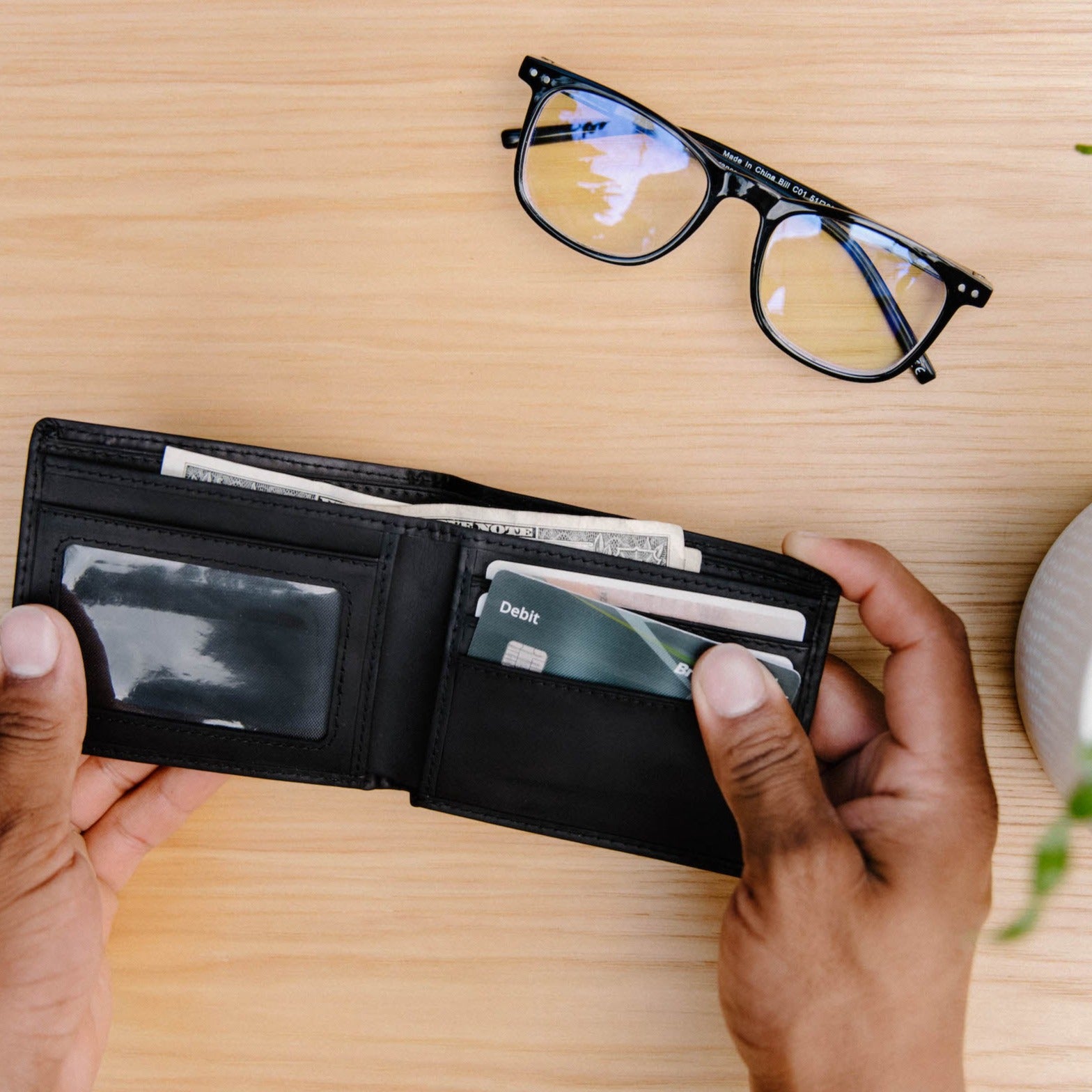 Open Bifold Wallet - Black Edition showing cards and cash