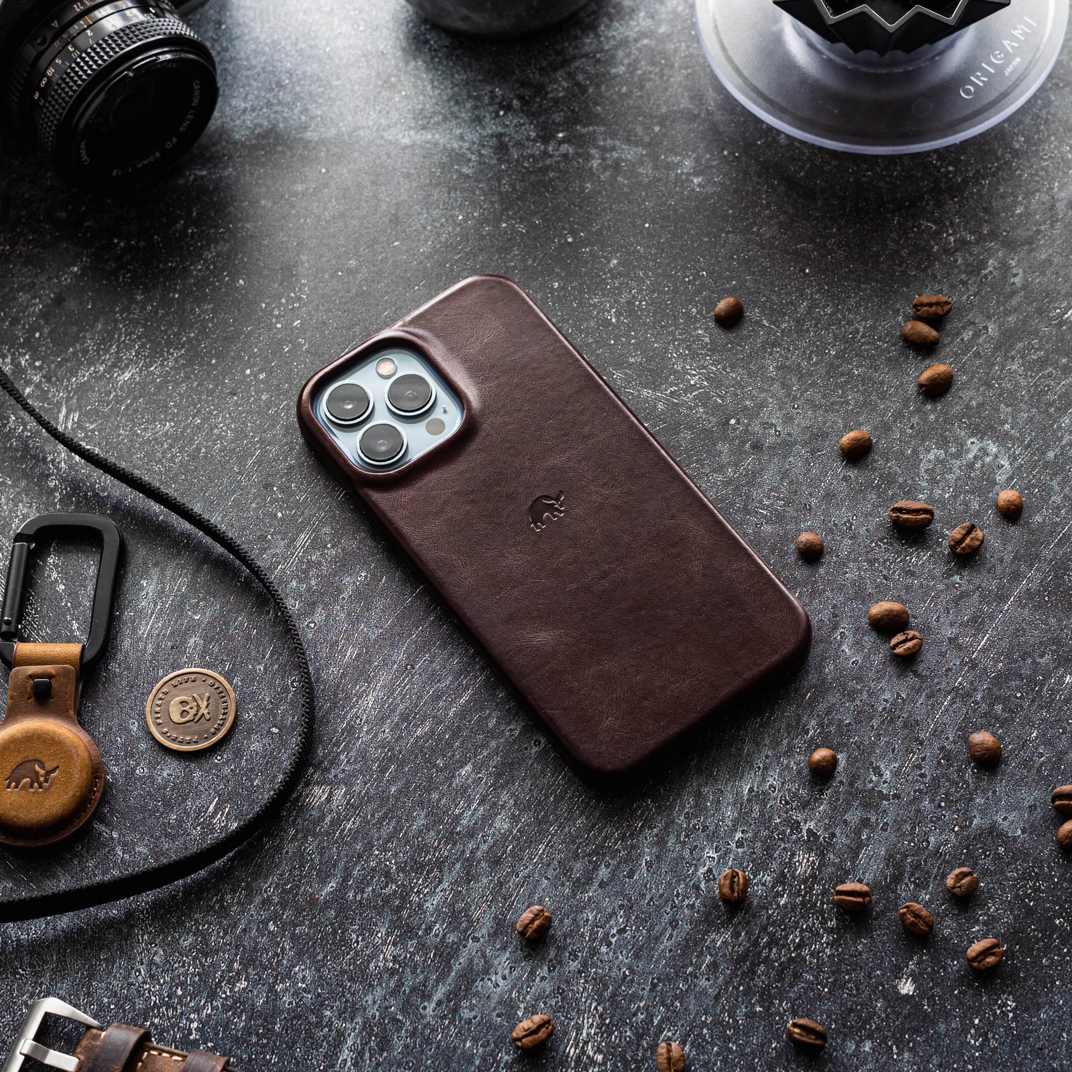 Minimalist bourbon leather iPhone case with embossed elephant, coffee beans, and ORIGAMI dripper